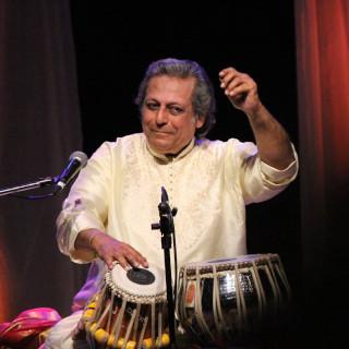 Swapan Chaudhuri playing tablas onstage.