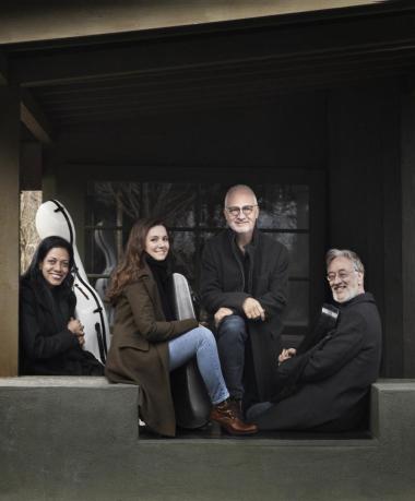 The Juilliard String Quartet poses for a photo while seated