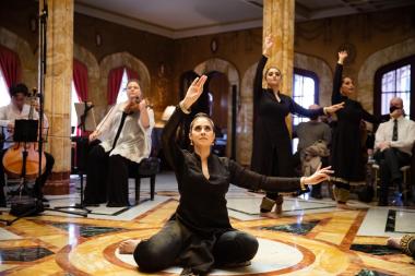 Leela dancers perform with musicians in an ornate room