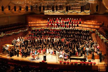The San Francisco Girls Chorus performing on a festively decorated stage
