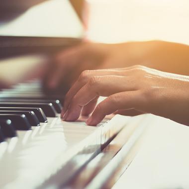 photo of hands playing piano