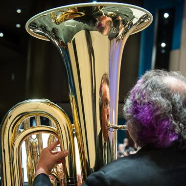 photo of man playing tuba