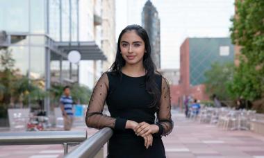 A Colburn Community student posing in the Colburn Plaza.