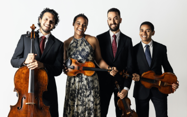 Ivalas Quartet holding their instruments and wearing formal attire