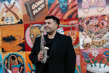 Solo shot of Michael Hernandez against a colorful mural