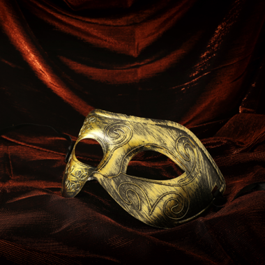image of gold half-mask against red velvet