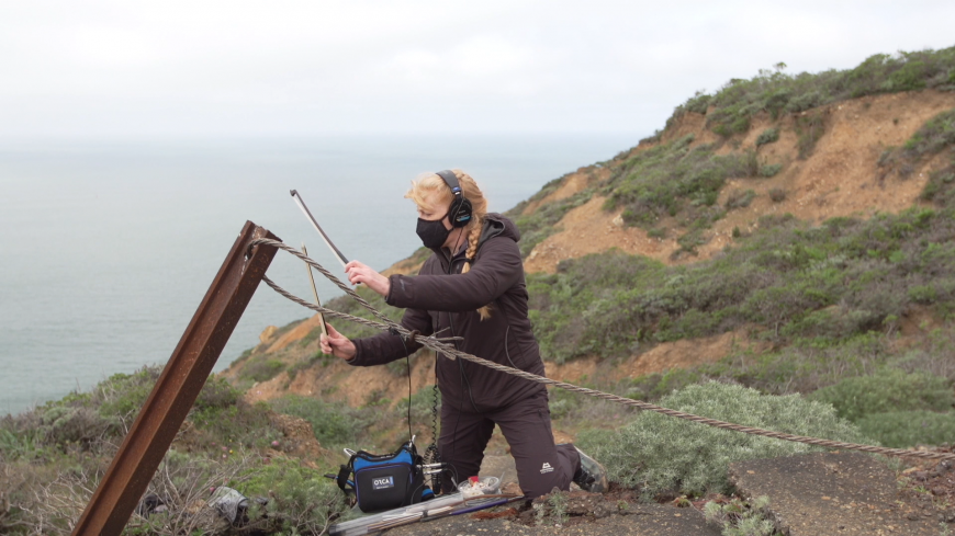 Cheryl Leonard bowing a steel cable at Marin Headlands