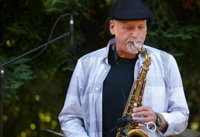 A portrait of Tod Dickow with his saxophone