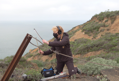 Cheryl Leonard bowing a steel cable at Marin Headlands