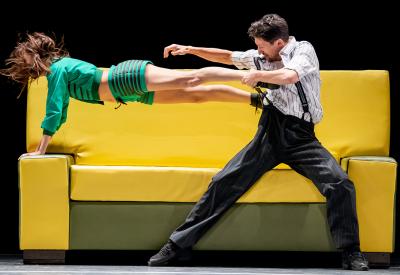 Two dancers mid-performance on a couch
