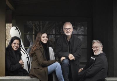The Juilliard String Quartet poses for a photo while seated