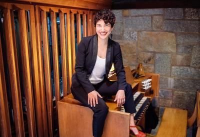 Organist Joy-Leilani Garbutt seated on a pipe organ