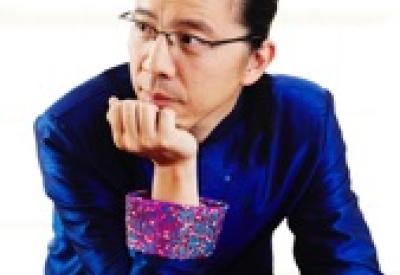 Piano virtuoso Frederic Chiu leans on piano