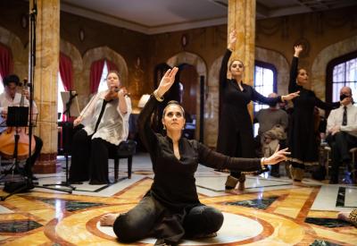 Leela dancers perform with musicians in an ornate room