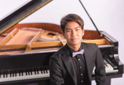 Soloist Stanford Yu sits at the piano