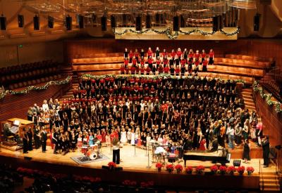 The San Francisco Girls Chorus performing on a festively decorated stage