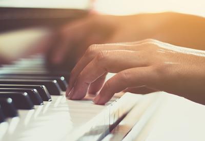 photo of hands playing piano