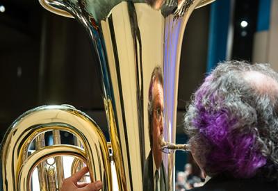 photo of man playing tuba