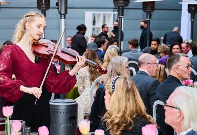 A Colburn Conservatory student performs a serenade on the Colburn Plaza.