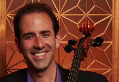 Cellist Isaac Pastor-Chermak holding his instrument