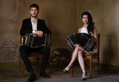 Man and woman seated holding bandoneones