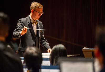 Dr. Matthew Sadowski conducting the UC Berkeley Wind Ensemble in Hertz Hall