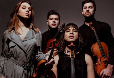 The Attaca Quartet in black and grey with their violins.