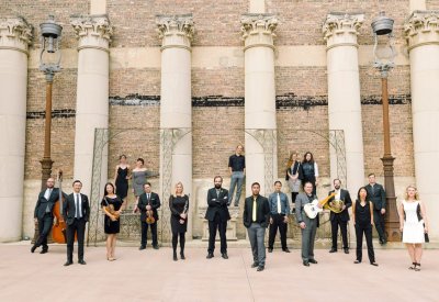 Taproot Musicians standing in formal clothes in front of a brick building.
