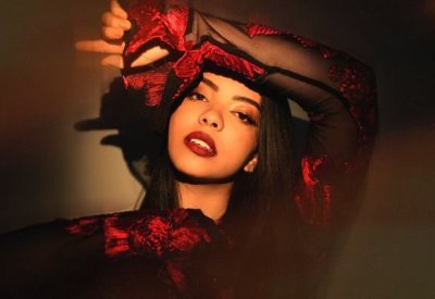 Lucía in a red and black top staring at the camera. 