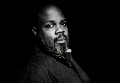 A black and white portrait of counter-tenor, Reginald Mobley.
