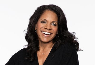 Portrait of Audra McDonald in front of a white backdrop 