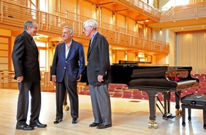 On the stage of the Weill Concert Hall: Robert Cole, Sanford Weill, and Donald Green<br>Photo by Linnea Mullins