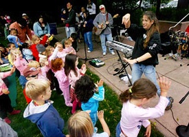 Charity and the JAMband, surrounded by kids dancing at the Park Chalet Charity and the JAMband