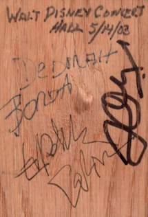 A piece of wood from the hall signed by Esa-Pekka Salonen, Frank Gehry, and Deborah Borda Disney Hall