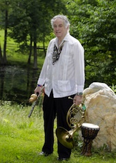 Multi-instrumentalist Amram poses on his farm with French horn, Irish pennywhistle, Chinese husai, and Arabic dumbek. His guayabera shirt is a gift from Latin jazz master Paquito d'Rivera.