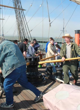 Ranger Peter Kasin (right) leads chantey workshoppers around the capstan of the <em>Balclutha</em>, to the tune of "Paddy Lay Back"<br>Photos by Jeff Kaliss Ranger Peter Kasin (right) leads chantey workshoppers around the capstan of the Balclutha, to the tune of "Paddy Lay Back". --- Photo by Jeff Kaliss