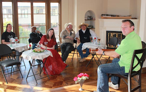 Sergei Chelakov (right) entertains his fellow musicians/contractors at the site of a house concert series hosted by J.J. Hollingsworth (in red dress)<br>Photo by Jeff Kaliss Sergei Chelakov (right) entertains his fellow musicians/contractors at the site of a new house concert series hosted by J.J. Hollingsworth (in red dress). Photo by Jeff Kaliss