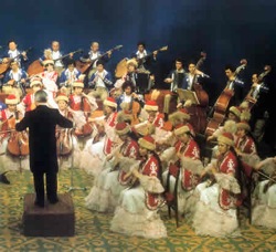 Kazakh orchestra, with the cobyz<br>section (front) in traditional dress