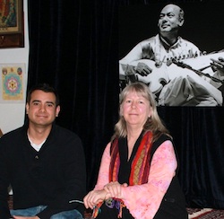 Alam Khan and Mary Khan beneath a portrait of the founder of the Ali Akbar College of Music in San Rafel<br>Photo by Jeff Kaliss Alam Khan and Mary Khan beneath a portrait of the founder of the Ali Akbar College of Music in San Rafel Photo by Jeff Kaliss
