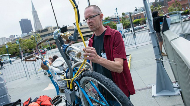 Tim Hawkinson with the bycicle component of his Exploratorium installation