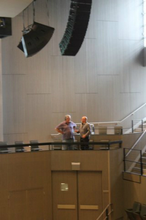 Acoustician Sam Berkow (right) confers with Jeff Briss of Cutting Edge Audio beneath one of the speaker arrays during a "retuning" of the Miner Auditorium at the SFJAZZ Center. (Photo by Jeff Kaliss)
