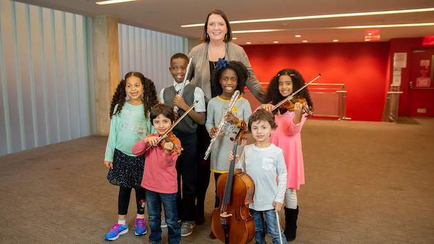 Kaufman Music Center Executive Director Kate Sheeran with budding musicians